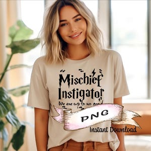 May include: Beige t-shirt with the words "Mischief Instigator" in black, along with the phrase "We are up to no good." A banner with "PNG" and "Instant Download" is also visible. The shirt is worn by a person.