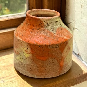 May include: A rustic wooden sign with the text "Welcome to our home" in white lettering. The sign features a distressed finish and a simple, inviting design, perfect for entryway decor.