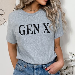 May include: A gray t-shirt with the text "GEN X" printed in black.