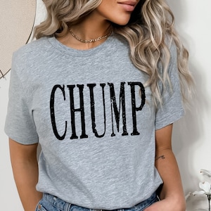 May include: Grey t-shirt with black text that reads "CHUMP" in a distressed font.