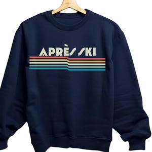 Apres ski retro 80's rainbow, vintage design with Apres Ski written over rainbow swish Apres ski sweatshirt is great gift or christmas present for a skiier or white christmas apres ski lover. cozy comfy trendy preppy top