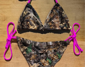 May include: A pink and brown camouflage print bikini with a triangle top and a high-cut bottom. The top has adjustable straps and the bottom has ties on the sides.