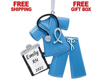 May include: Blue and white personalized Christmas ornament featuring a nurse's scrubs, stethoscope, and a clipboard with the text "Emily RN 2025".