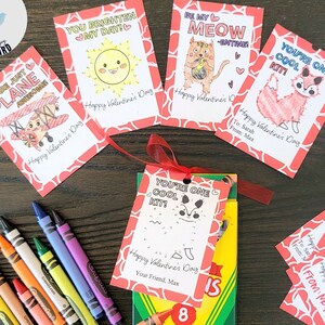May include: Valentine's Day cards with colouring and connect-the-dots designs, featuring a plane, sun, cat, and fox illustrations. A box of 8 crayons is included. Text reads "You are just plane awesome" and "You're one cool kit!"