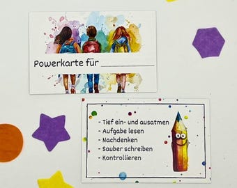 May include: A white card with colorful watercolor splatters and three children with backpacks walking. The card says "Powerkarte für" with a blank line for a name. A second card with a smiling pencil and the text "Tief ein- und ausatmen - Aufgabe lesen - Nachdenken - Sauber schreiben - Kontrollieren".