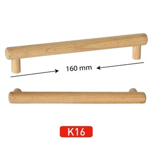 May include: A wooden cabinet pull with a 160 mm length. The pull is made of natural wood and has a simple, rectangular design. The pull is labeled "K16".