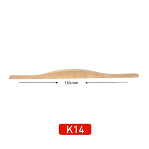 May include: A light wood cabinet door pull with a curved shape. The pull measures 130 mm in length. The pull is labeled "K14".