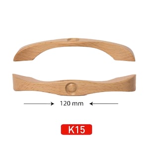 May include: Two light-colored wooden cabinet handles, each with a curved design and a circular indentation. The handles are 120 mm long. The label "K15" is in a red rectangle.