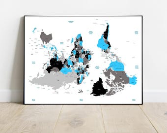 May include: A black and white world map with countries outlined in blue and gray. The map is in a black frame and is hanging on a white wall.