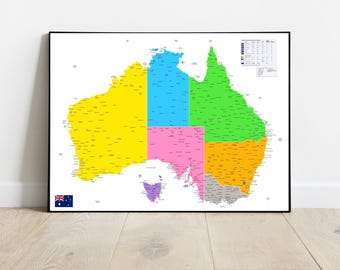 May include: A framed map of Australia, divided into colorful states. The map features a key with color-coded information and the Australian flag in the lower left corner. The map is set against a white wall and a light wood floor.