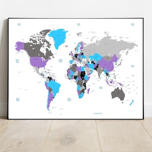 May include: A framed world map with countries colored in shades of grey, purple, blue, and black. The map is set against a white background and framed in black. The oceans are labelled in blue text. The map is displayed on a light wood floor.