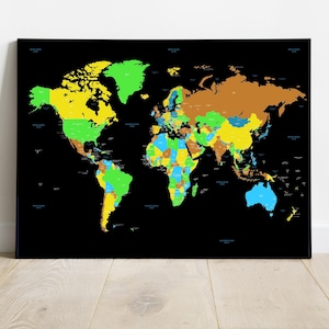 May include: A colorful world map on a black background. Countries are distinguished by various colors, including green, yellow, blue, and brown. The map is framed and displayed against a white wall and wooden floor.