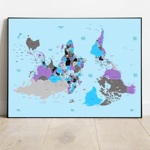 May include: A framed world map with a light blue background. The continents are colored in shades of gray, purple, and blue, with black borders and labels. The map is displayed on a light wood floor against a white wall.