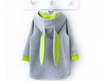May include: Gray hooded sweatshirt with long sleeves and lime green bunny ears attached to the hood. The sweatshirt has lime green trim on the sleeves and hood.