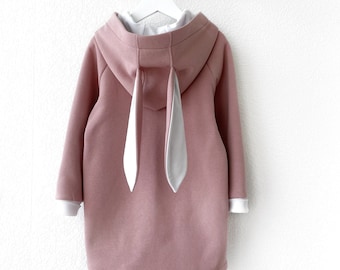May include: A pink hooded sweatshirt with long sleeves and white bunny ears attached to the hood.