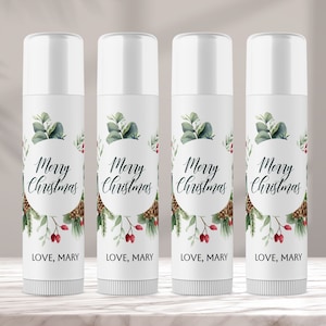 May include: Four white tubes with labels that say "Merry Christmas" in a circle with a green and red floral design. The labels also say "LOVE, MARY" at the bottom.