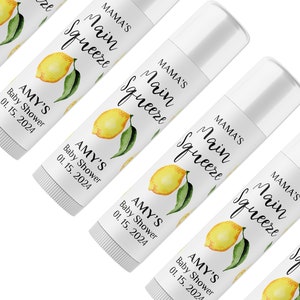 May include: White lip balm tubes with labels featuring a watercolor lemon design and the text "MAMA'S Main Squeeze." The labels also include "AMY'S Baby Shower 01. 15. 2024."