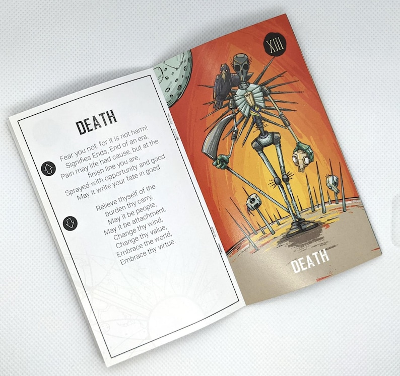 May include: An open tarot card spread featuring the Death card. The card has a skeletal figure with a gas mask and a bird on its shoulder, set against an orange and brown background. The card's text reads "DEATH" and includes a poem.