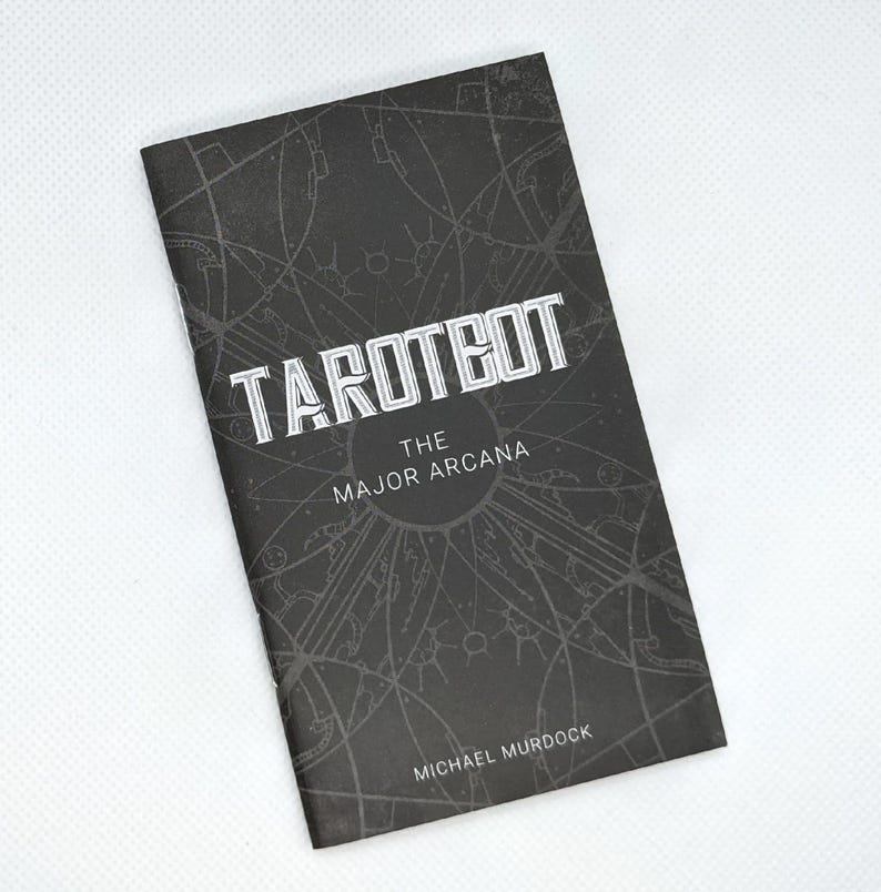 May include: A black booklet titled "TAROTBOT" with "THE MAJOR ARCANA" and the author's name, Michael Murdock, printed on the cover. The cover features a geometric design in a lighter shade of gray.