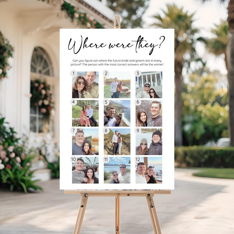 May include: A white sign on a wooden easel with the text "Where were they?" in elegant script. The sign features 12 small photos and instructions for a game, likely for a wedding or engagement party. The game asks guests to guess the location of the photos.