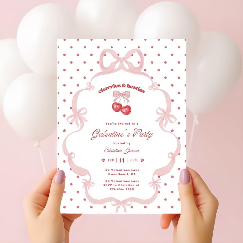 May include: A Galentine's Party invitation with a pink and white polka dot background. The invitation features pink bows and the text "cherries & besties". The invitation is held by a person with manicured nails.