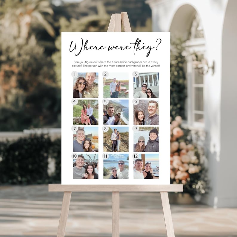 May include: A white sign on a wooden easel with the text "Where were they?" in elegant script. The sign features 12 small photos, likely for a game at a wedding or engagement party. The text below asks, "Can you figure out where the future bride and groom are in every picture?"