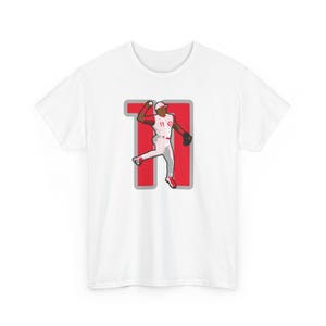 May include: White t-shirt with a red number 11 and a baseball player in a red and white uniform throwing a ball.