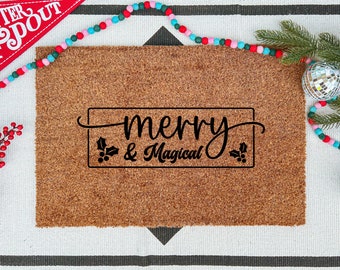 May include: A rectangular coir doormat with the words "merry & magical" in a black decorative font. The mat is surrounded by Christmas decorations, including a red pennant, a beaded garland, and disco ball ornaments.