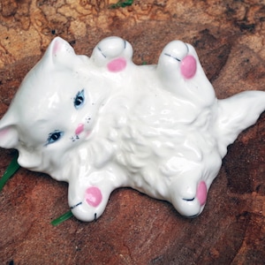 Ceramic White Kitten on back in playful mode.