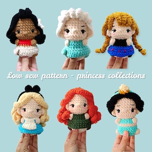 May include: A collection of six crocheted princess dolls, each with unique features and outfits. The dolls are held up by fingers. The text "Low sew pattern - princess collections" is displayed in the image.