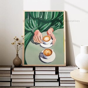 May include: A painting of two cups of coffee with a green striped shirt in the background.
