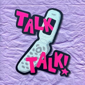 May include: A retro-style patch featuring a flip phone design with the words "TALK TALK!" in bright pink letters. The patch has a black border and a star accent, set against a textured purple background.