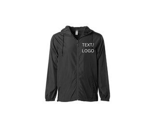 May include: Black hooded windbreaker jacket with a zipper closure. The jacket has a white embroidered design that says "TEXT/LOGO" on the front.