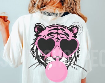 May include: A white t-shirt with a pink tiger wearing heart-shaped sunglasses and blowing a pink bubble. The tiger has black stripes and a black nose.