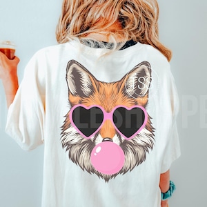 May include: A white t-shirt with a graphic of a fox wearing pink heart-shaped sunglasses and blowing a pink bubble.