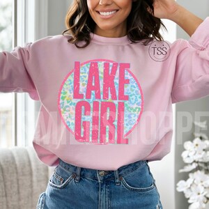 May include: Pink sweatshirt with a circle graphic that says "LAKE GIRL" in pink letters with a blue and green leopard print background.
