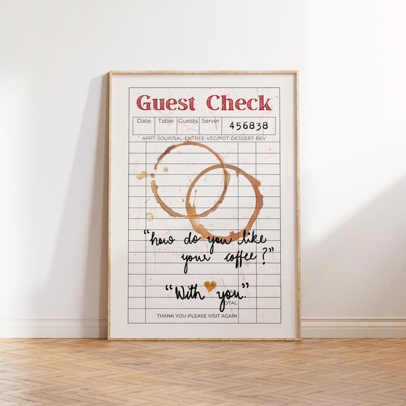 Pode incluir: Um cheque de restaurante branco e marrom com um t&iacute;tulo vermelho "Guest Check". O cheque tem um padr&atilde;o de grade com dois an&eacute;is de x&iacute;caras de caf&eacute;. O texto "how do you like your coffee?" e "With you." est&aacute; escrito &agrave; m&atilde;o no cheque.