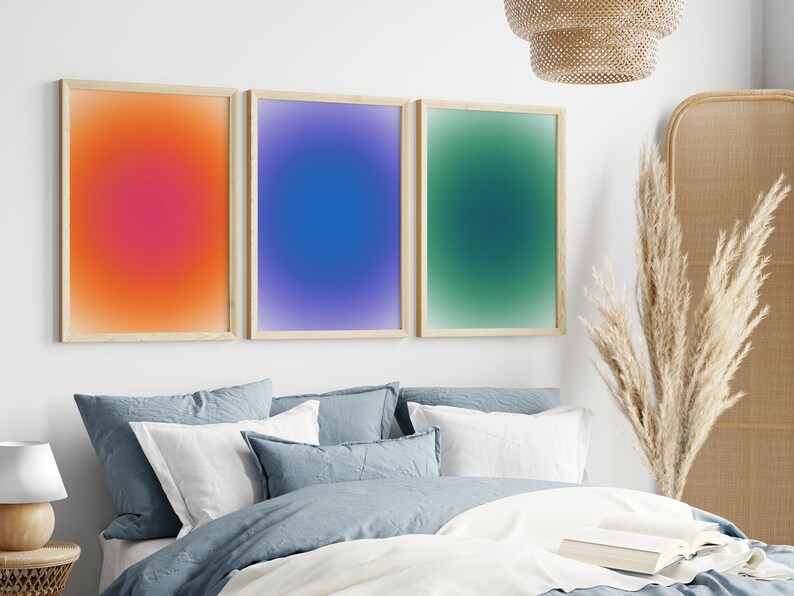 Peut inclure: Trois impressions d'art abstrait encadr&eacute;es avec des fonds de couleur d&eacute;grad&eacute;s. Les impressions sont dans une chambre &agrave; coucher avec un lit, des oreillers et une lampe.