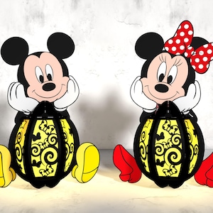 Może przedstawiać: Para czarno-żółtych lampionów z postaciami Myszki Miki i Minnie. Lampiony mają kształt kuli z czarno-żółtym wzorem w postaci spirali. Myszka Miki ma na sobie czerwone spodenki i żółte buty. Minnie ma na sobie czerwoną sukienkę i czerwone buty z czerwoną kokardką w białe kropki.