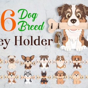 May include: A wooden key holder featuring a dog design with a bone-shaped key rack. The key holder has the text "16 Dog Breed Key Holder". The image shows various dog breeds holding bone-shaped key racks.