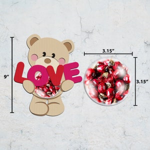 May include: A tan teddy bear figure holding the word "LOVE" in red and pink. The bear's belly is a clear, round container filled with red candies. The bear is 9 inches tall, and the container is 3.15 inches in diameter.