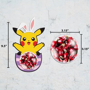 May include: A yellow Pikachu cartoon character wearing bunny ears sits inside a purple and white Easter egg. The egg is filled with red and white candy. The character is 9.5 inches tall and the candy is in a 3.15 inch diameter clear plastic container.
