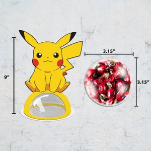 May include: A yellow Pikachu character figurine sits on a yellow base with a clear plastic dome. The dome is 3.15 inches in diameter and the figurine is 9 inches tall. The figurine is holding a red and white candy.