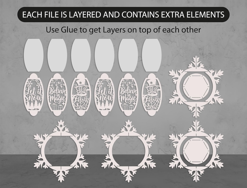 May include: White laser-cut Christmas ornaments and snowflake designs. The image includes oval-shaped ornaments with phrases like "Let it Snow" and "Believe in Magic". The text "EACH FILE IS LAYERED AND CONTAINS EXTRA ELEMENTS" is at the top.