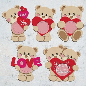May include: A collection of tan teddy bear cutouts holding red and pink hearts. Some hearts have the words "I Love You", "LOVE", or "Be My Valentine". The bears have pink cheeks and are set against a textured white background.