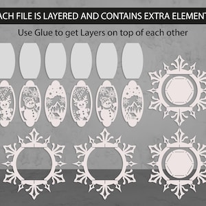 May include: White laser-cut Christmas ornaments and snowflake designs. The image includes oval ornaments with reindeer, snowmen, and winter scenes, along with snowflake-shaped frames. Text at the top reads: "EACH FILE IS LAYERED AND CONTAINS EXTRA ELEMENTS".