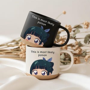 Könnte beinhalten: Zwei Keramiktassen, eine mattschwarz und eine gesprenkelt cremefarben, mit einer Grafik einer Anime-Figur mit dunklem Haar und blauer Schleife. Der Text "This is most likely poison" ist in Schwarz oder Weiß über der Figur aufgedruckt.