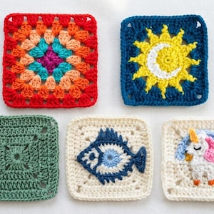 May include: Five colorful, square crochet pieces. One features a sun and moon design, another a fish, and a third a unicorn. The other two have geometric patterns. The pieces are in shades of red, blue, green, yellow, and white.