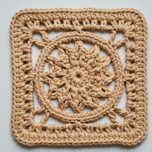 May include: A square, tan crochet doily with a central starburst design. The doily features an openwork pattern within a square frame, showcasing intricate stitch work. The overall aesthetic is handmade and rustic.