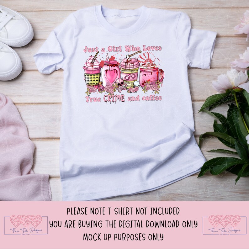 May include: A white t-shirt with a pink graphic design of coffee cups with crime-related imagery. The text "Just a Girl Who Loves True Crime and Coffee" is printed on the shirt.